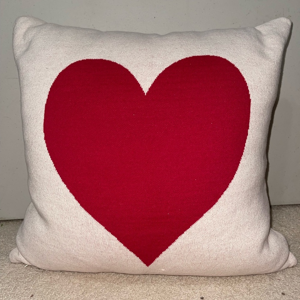 Cream colored fluffy soft pillow with red accent heart
